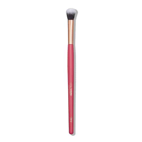 Makeup brush with pink handle and gold ferrule on a white background