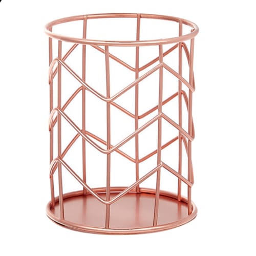 Rose gold metal basket with geometric design on a white background