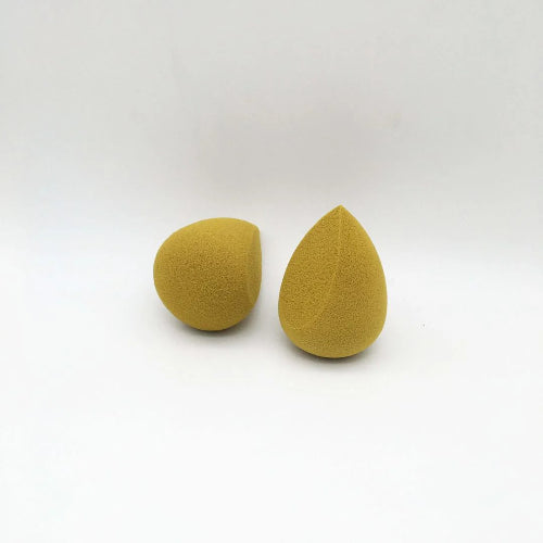 Two yellow teardrop-shaped sponges on a white background