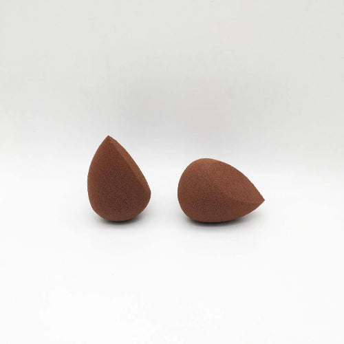 Two brown makeup sponges on a white background