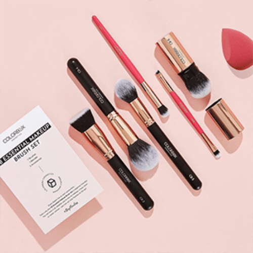 Makeup brush set with a Colorfuluk branded card on a pink background